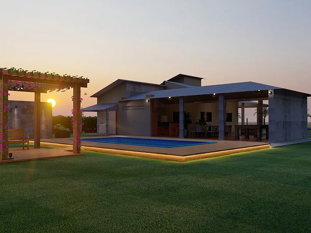 Casa com pérgola, piscina iluminada e gramado ao pôr do sol